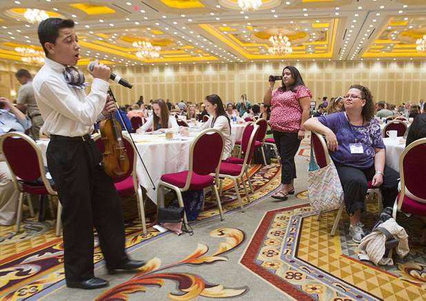 Denilson Morales, 14, a Las Vegas Academy student, sings during a Clark County School District orientation session for new teachers at the Venetian Thursday, Aug. 15, 2013. Over 1,700 teachers took part in the orientation.