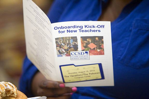 A teacher looks over a schedule for professional development sessions during a Clark County School District orientation for new teachers at the Venetian Thursday, Aug. 15, 2013. Over 1,700 teachers took part in the orientation.