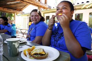 Camper Emily Lai, 14, has fun with an orange slice during lunch at Camp Heart and Sole at Torino Ranch in Lovell Canyon on Saturday, August 17, 2013.