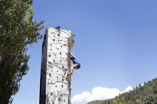 Camper Stephanie Diaz, 15, climbs the rock wall at Camp Heart and Sole at Torino Ranch in Lovell Canyon on Saturday, August 17, 2013.