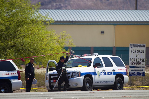 Henderson Police officers take measurements as police investigate an officer-involved shooting near Boulder Highway and College Drive in Henderson, Aug. 20, 2013. STEVE MARCUS