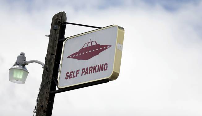 A sign indicates UFO parking at the Little A'Le'Inn, located nine miles up the road from the military testing base known as Area 51, in Rachel, Nev., Aug. 20, 2013. 