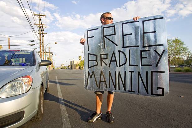 Robbie Andrew displays his sign on the way to join a protest in support of Army Pfc. Bradley Manning in front of the Lloyd George Federal Building in downtown Las Vegas Wednesday, Aug. 21, 2013. A military judge sentenced Manning to 35 years in prison for leaking hundreds of thousands of classified documents to WikiLeaks.