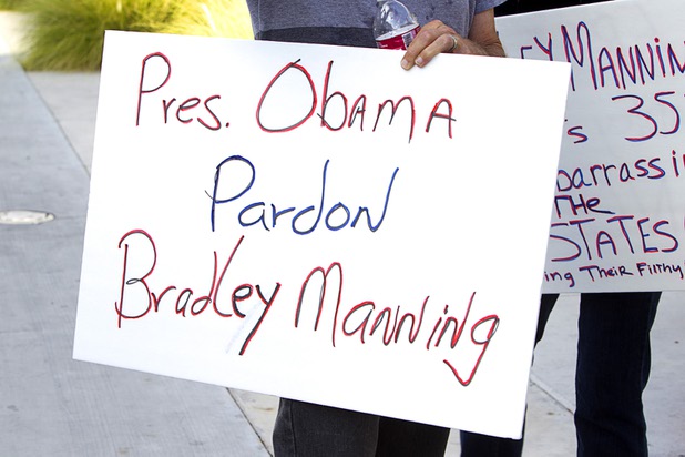 A picketer holds a message for President Barack Obama during a protest in support of Army Pfc. Bradley Manning in front of the Lloyd George Federal Building in downtown Las Vegas Wednesday, Aug. 21, 2013. A military judge sentenced Manning to 35 years in prison for leaking hundreds of thousands of classified documents to WikiLeaks.
