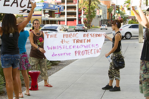 Mary Bel Gomez, left, and Claire Estrella unroll a banner during a protest in support of Army Pfc. Bradley Manning in front of the Lloyd George Federal Building in downtown Las Vegas Wednesday, Aug. 21, 2013. A military judge sentenced Manning to 35 years in prison for leaking hundreds of thousands of classified documents to WikiLeaks.
