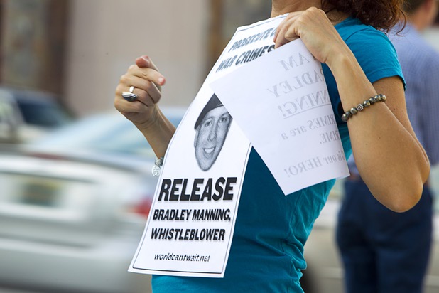 Lilly Natures Blessings holds a flier in support of Army Pfc. Bradley Manning in front of the Lloyd George Federal Building in downtown Las Vegas Wednesday, Aug. 21, 2013. A military judge sentenced Manning to 35 years in prison for leaking hundreds of thousands of classified documents to WikiLeaks.