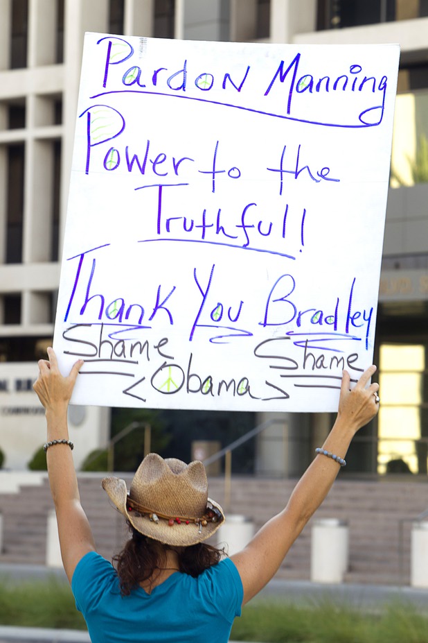 Lilly Natures Blessings holds a sign calling for the pardon of Army Pfc. Bradley Manning during a picket in front of the Lloyd George Federal Building in downtown Las Vegas Wednesday, Aug. 21, 2013. A military judge sentenced Manning to 35 years in prison for leaking hundreds of thousands of classified documents to WikiLeaks.
