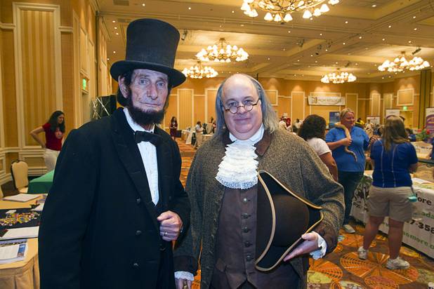 William Peck as Abraham Lincoln and Brian Patrick Mulligan as Ben Franklin poses at the "Hands on History" booth during MGM Resorts' annual Educator Appreciation Day and Back to School Fair at the Mirage Thursday, Aug. 22, 2013. More than 18,000 teachers were invited to gather schools supplies donated by MGM Resorts employees.