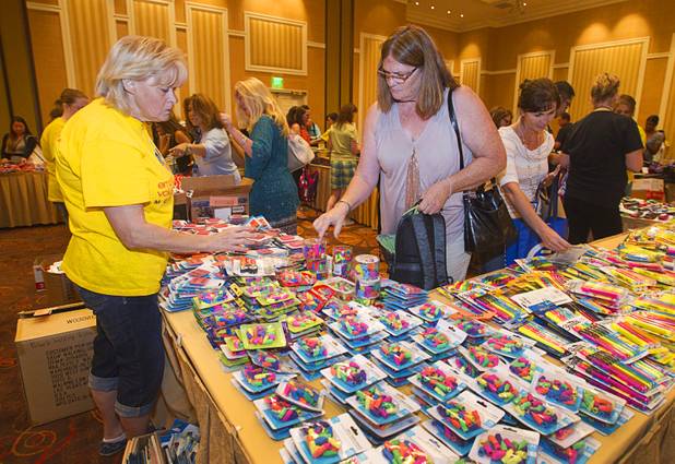 Charlene Wiesenborn, center, a science teacher at Boulder City High School, picks up supplies during MGM Resorts' annual Educator Appreciation Day and Back to School Fair at the Mirage Thursday, Aug. 22, 2013. More than 18,000 teachers were invited to gather schools supplies donated by MGM Resorts employees.
