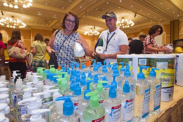 Teachers Mary Kay Lein and Leandro Gonzalez pick up hand sanitizer during MGM Resorts' annual Educator Appreciation Day and Back to School Fair at the Mirage Thursday, Aug. 22, 2013. Lein was his computer lab teacher when he was a student at Advanced Technologies Academy, he said. Gonzalez is now a Spanish teacher at Spring Valley High School.