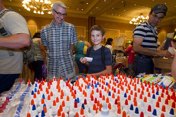 Brighton Temple, 9, helps his dad pick up school supplies during MGM Resorts' annual Educator Appreciation Day and Back to School Fair at the Mirage Thursday, Aug. 22, 2013. Danny Temple is a reading teacher at Findlay Middle School.
