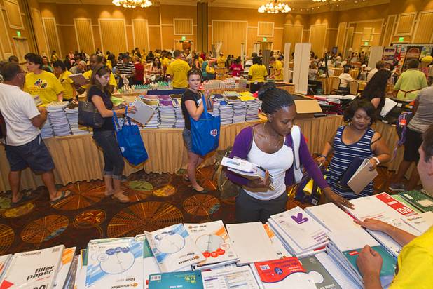 Lashaundra Taylor, a fourth grade teacher at Elizondo Elementary School picks up supplies during MGM Resorts' annual Educator Appreciation Day and Back to School Fair at the Mirage Thursday, Aug. 22, 2013. More than 18,000 teachers were invited to gather schools supplies donated by MGM Resorts employees.