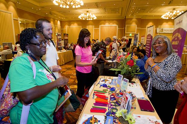 Zenia Freeman, left, a fourth grade teacher at Helen Herr Elementary School, talks with Coral Santiago, right, education department manager at the Las Vegas Urban League during MGM Resorts' annual Educator Appreciation Day and Back to School Fair at the Mirage Thursday, Aug. 22, 2013. More than 18,000 teachers were invited to gather schools supplies donated by MGM Resorts employees.