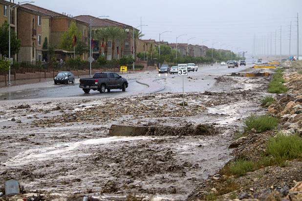 Vehicles turn around as storm runoff floods Grand Teton Drive near Grand Canyon Drive on Sunday, Aug. 25, 2013. 