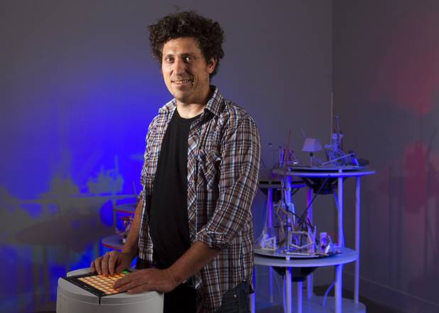 Artist David Sanchez Burr stands by a control panel in front of the New Citadel at the P3 Gallery in the Cosmopolitan Sunday, Aug. 25, 2013.