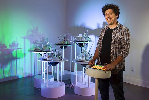 Artist David Sanchez Burr stands by a control panel in front of the New Citadel at the P3 Gallery in the Cosmopolitan Sunday, Aug. 25, 2013.