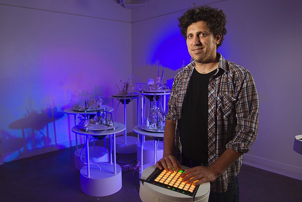 Artist David Sanchez Burr stands by a control panel in front of the New Citadel at the P3 Gallery in the Cosmopolitan Sunday, Aug. 25, 2013.
