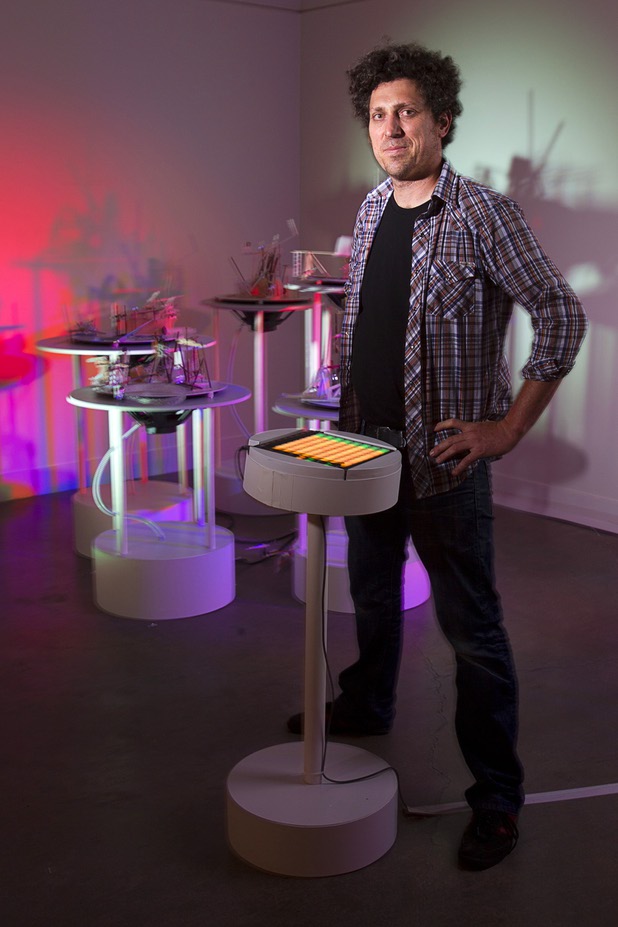 Artist David Sanchez Burr stands by a control panel in front of the New Citadel at the P3 Gallery in the Cosmopolitan Sunday, Aug. 25, 2013.