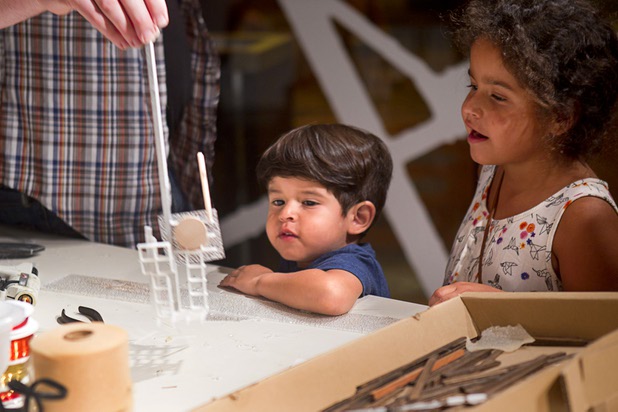 Davio, 3, and Katelyn Lopez, 8, of Long Beach, watch as artist David Sanchez Burr creates a sculpture for the New Citadel at the P3 Gallery in the Cosmopolitan Sunday, Aug. 25, 2013.