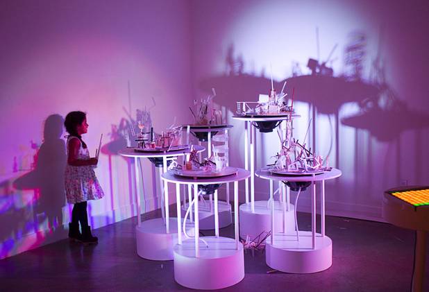 Katelyn Lopez, 8, of Long Beach, places her sculpture on the New Citadel at the P3 Gallery in the Cosmopolitan Sunday, Aug. 25, 2013.