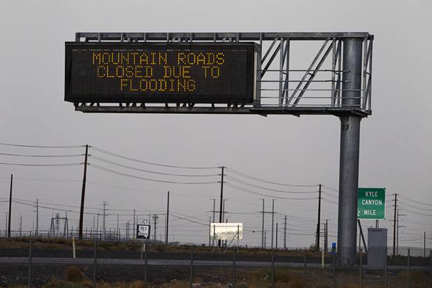 A sign on U.S. 95 announces the closure of Mt. Charleston Roads to to flooding Sunday, Aug. 25, 2013.