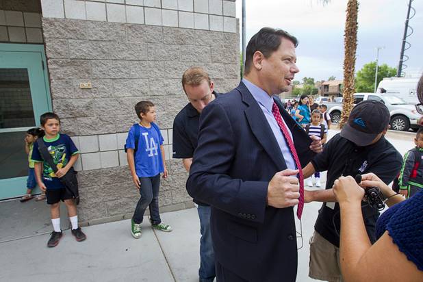 Television videographers put wireless microphones on Clark County School District Superintendent Pat Skorkowsky before a tour of Cambeiro Elementary School Monday, Aug. 26, 2013. The school is a "Zoom" school, one of 14 CCSD schools that will receive additional state money and resources to help students who don't speak English.