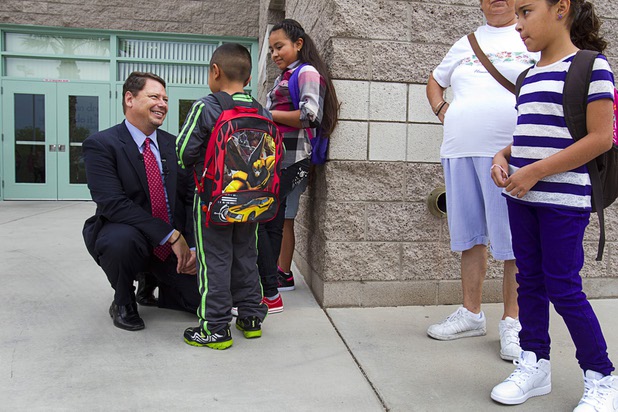 Clark County School District Superintendent Pat Skorkowsky, left, talks with fourth grader Emily Garcia and her brother Eduardo, a first grader, at Cambeiro Elementary School during the first day of school Monday, Aug. 26, 2013. The school is a "Zoom" school, one of 14 CCSD schools that will receive additional state money and resources to help students who don't speak English.