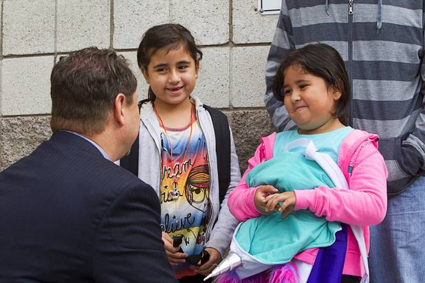 Clark County School District Superintendent Pat Skorkowsky listens to second grader Alyssa Bautista, left, and her Alitcy, a first grader, during the first day of school at Cambeiro Elementary School Monday, Aug. 26, 2013. The school is a "Zoom" school, one of 14 CCSD schools that will receive additional state money and resources to help students who don't speak English.