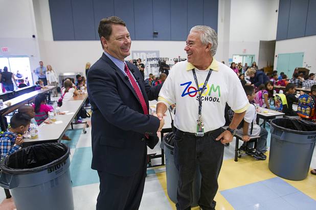 Clark County School District Superintendent Pat Skorkowsky shakes hands with James Stanton, an early childhood education aide, during the first day of school at Cambeiro Elementary School Monday, Aug. 26, 2013. The school is a "Zoom" school, one of 14 CCSD schools that will receive additional state money and resources to help students who don't speak English.