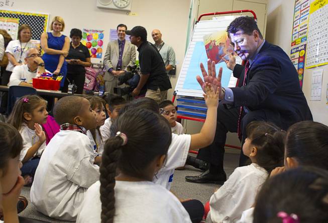 Clark County School District Superintendent Pat Skorkowsky gets a high five while reading to kindergarten students during the first day of school at Cambeiro Elementary School Monday, Aug. 26, 2013. The school is a "Zoom" school, one of 14 CCSD schools that will receive additional state money and resources to help students who don't speak English.