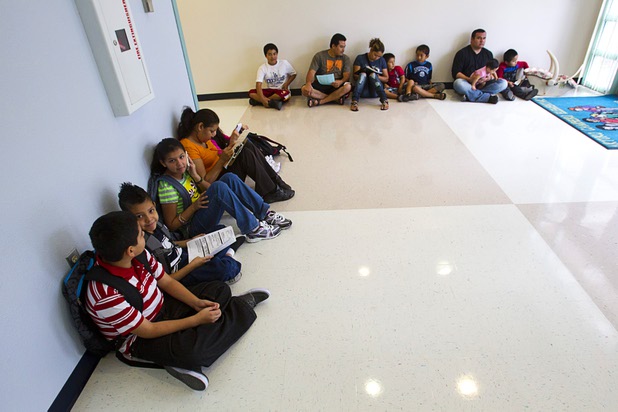 Students wait as their parents fill out enrollment paperwork during the first day of school at Cambeiro Elementary School Monday, Aug. 26, 2013. The school is a "Zoom" school, one of 14 CCSD schools that will receive additional state money and resources to help students who don't speak English.