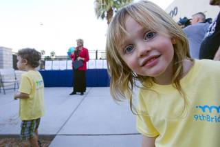 Mia Castellarin, 4, looks at the camera as Las Vegas Mayor Carolyn Goodman, center, speaks during a grand opening ceremony for the 9th Bridge School in downtown Las Vegas Tuesday, Aug. 27, 2013. The private school/early childhood learning center, part of the Downtown Project, opened August 26 with infants through kindergarten students and will gradually add grades.