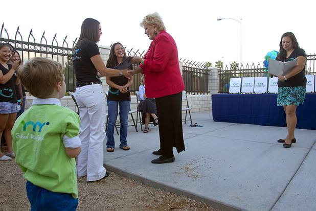 School director Nikki Goldstein, left, receives a certificate of congratulations from Las Vegas Mayor Carolyn Goodman as Connie Yeh head of education initiative for the Downtown Project, looks on during a grand opening ceremony for the 9th Bridge School in downtown Las Vegas Tuesday, Aug. 27, 2013. The private school/early childhood learning center, part of the Downtown Project, opened August 26 with infants through kindergarten students and will gradually add grades.