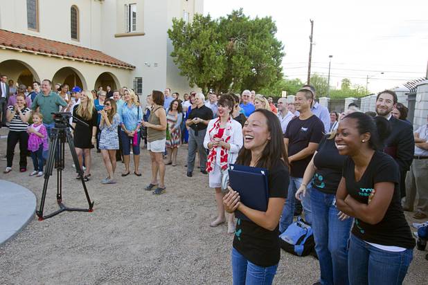 Staff, parents, and guests attend a grand opening ceremony for the 9th Bridge School in downtown Las Vegas Tuesday, Aug. 27, 2013. The private school/early childhood learning center, part of the Downtown Project, opened August 26 with infants through kindergarten students and will gradually add grades.