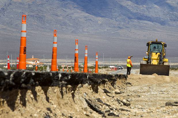 Road crews work to repair a portion of Kyle Canyon Road Tuesday, Aug. 27, 2013. The area was hit hard by storm runoff during Sunday's storm. Kyle Canyon Road reopened to the public Tuesday.