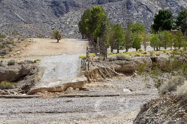 A wash cuts across Turtle Back Ranch Road near Kyle Canyon Road Tuesday, Aug. 27, 2013. The area was hit hard by storm runoff during Sunday's storm. Kyle Canyon Road reopened to the public Tuesday.
