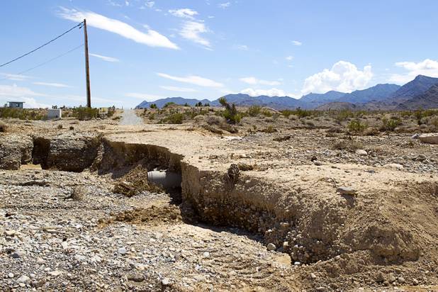 Damage is shown on an access road off of Kyle Canyon Road Tuesday, Aug. 27, 2013. The area was hit hard by storm runoff during Sunday's storm. Kyle Canyon Road reopened to the public Tuesday.