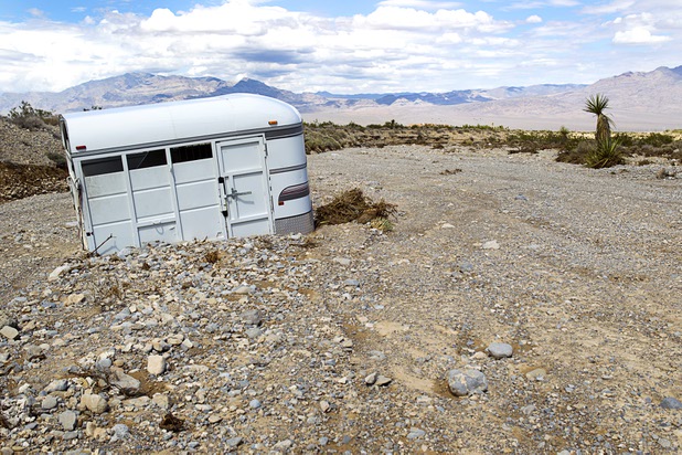 A horse trailer is shown partially buried in sand near Turtle Back Ranch and Kyle Canyon roads Tuesday, Aug. 27, 2013. The area was hit hard by storm runoff during Sunday's storm. Kyle Canyon Road reopened to the public Tuesday.