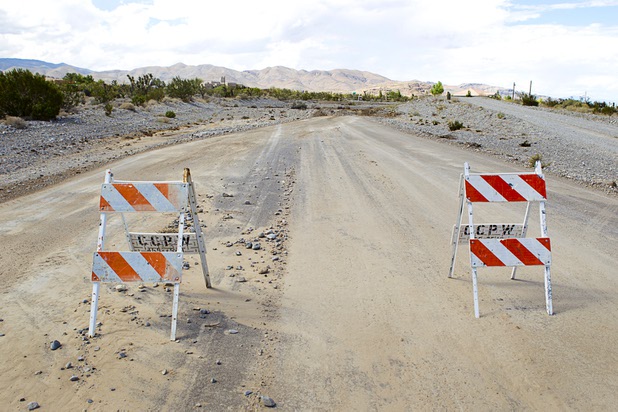 Traffic barriers are shown on Scottie Road near Grand Teton Drive in Lower Kyle Canyon Tuesday, Aug. 27, 2013. The area was hit hard by storm runoff during Sunday's storm. Kyle Canyon Road reopened to the public Tuesday.