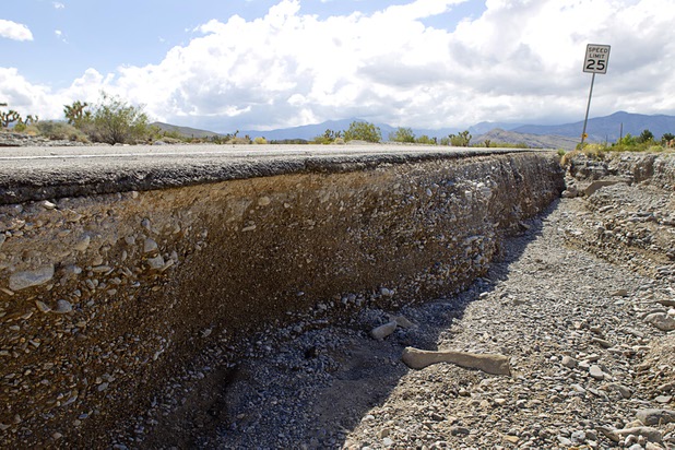 A gully, carved by storm runoff is shown at the side of Grand Teton Drive in Lower Kyle Canyon Tuesday, Aug. 27, 2013. The area was hit hard by storm runoff during Sunday's storm. Kyle Canyon Road reopened to the public Tuesday.