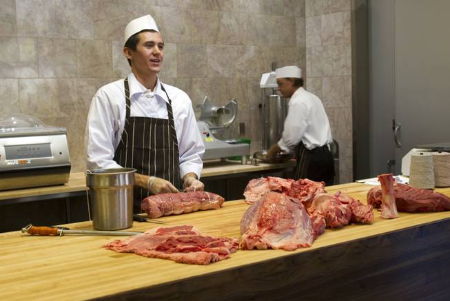 Butcher Trevor Morones, 23, talks to journalists and guests as he ties an eye round during a preview of the new Echo & Rig Butcher and Steakhouse, 440 S. Rampart Blvd., at Tivoli Village on Tuesday, Aug. 27, 2013.