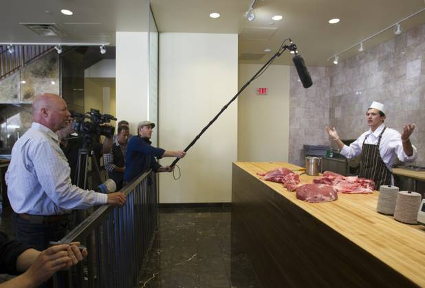 Butcher Trevor Morones, 23, talks to journalists and guests as he ties an eye round during a preview of the new Echo & Rig Butcher and Steakhouse, 440 S. Rampart Blvd., at Tivoli Village on Tuesday, Aug. 27, 2013.