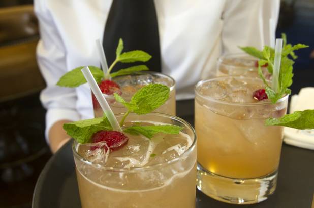 A waitress holds a tray of Punch 1602 cocktails during a preview of the new Echo & Rig Butcher and Steakhouse, 440 S. Rampart Blvd., at Tivoli Village on Tuesday, Aug. 27, 2013.