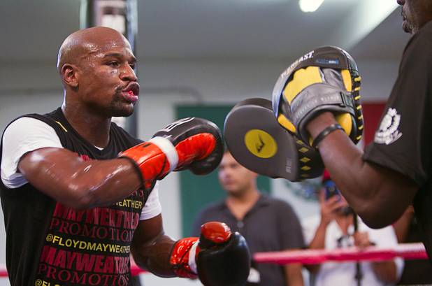 Undefeated boxer Floyd Mayweather Jr. works on his timing with his uncle and trainer Roger Mayweather at the Mayweather Boxing Club Wednesday, August 28, 2013. Mayweather will face Canelo Alvarez of Mexico in a WBC/WBA 154-pound title fight at the MGM Grand Garden Arena on September 14.