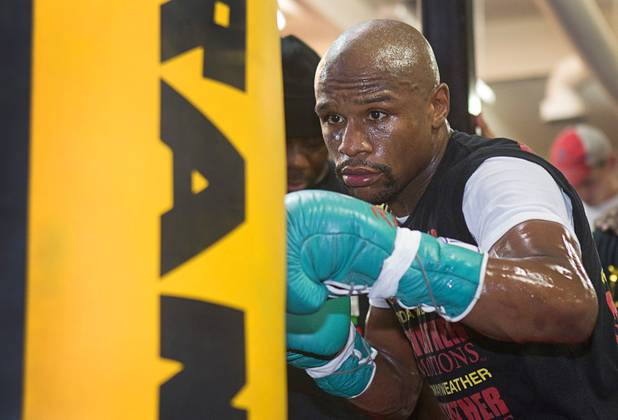 Undefeated boxer Floyd Mayweather Jr. hits a heavy bag at the Mayweather Boxing Club Wednesday, August 28, 2013. Mayweather will face Canelo Alvarez of Mexico in a WBC/WBA 154-pound title fight at the MGM Grand Garden Arena on September 14.