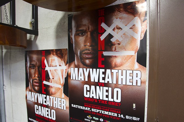 Posters with the face of Canelo Alvarez marked out with tape are shown at the Mayweather Boxing Club Wednesday, August 28, 2013. Mayweather will face Alvarez of Mexico in a WBC/WBA 154-pound title fight at the MGM Grand Garden Arena on September 14.