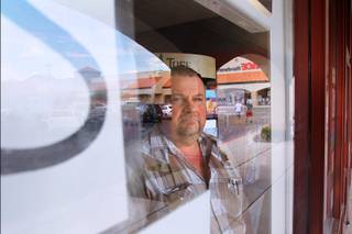 Howard Rogers is the owner of Postal Express in a strip mall at 4900 West Lone Mountain Road August 28, 2013.