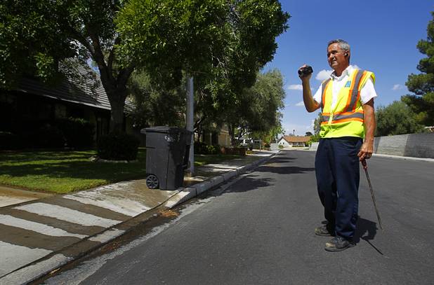 Robert Kern, a meter services field representative for the Southern Nevada Water Authority, documents water waste at a home near South Rancho Drive and West Oakey Boulevard on Thursday, Aug. 29, 2013. The lawn sprinklers were running at a prohibited time (between 11 a.m. and 7 p.m.) and overwatering so that water flowed into the gutter.