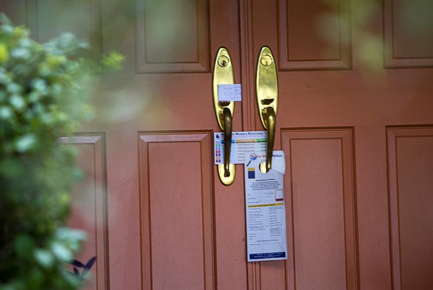 A water waste notice and watering schedule are left at a home near Rancho Dr. and Oakey Blvd. Thursday, August 29, 2013. The lawn sprinklers were running at a prohibited time (between 11 a.m. and 7 p.m.) and overwatering so that water flowed into the gutter.