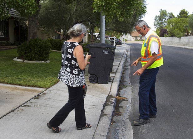 Robert Kern, a meter services field representative for the Southern Nevada Water Authority (SNWA), talks with a homeowner in a neighborhood near Rancho Dr. and Oakey Blvd. Thursday, August 29, 2013. The lawn sprinklers at the home were running at a prohibited time (between 11 a.m. and 7 p.m.) and overwatering so that water flowed into the gutter.